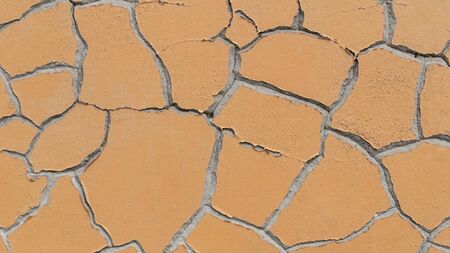 Cracked wall in shades of orange. Perfect texture and background.
