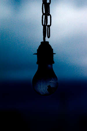 A light bulb against a dark sky