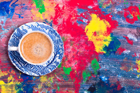 Freshly brewed coffee in a blue stylish cup on a white-blue backgroundの写真素材