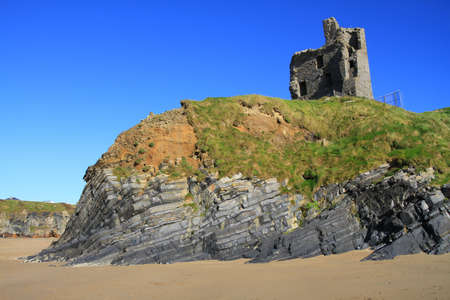 Ballybunion Castle on the rocks in the west coast of Irelandの写真素材