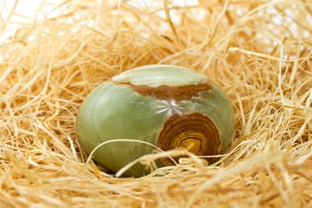 Artificial egg made from stone in the nestの写真素材