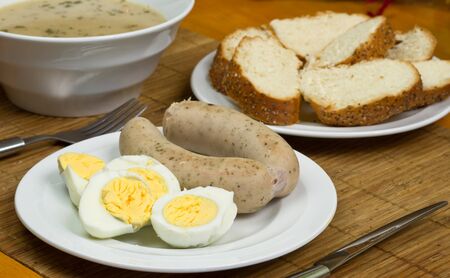 Traditional white borsch soup with eggs and sausagesの写真素材