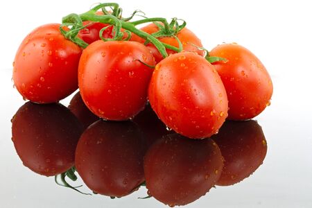 Fresh tomatoes with glass reflectionの写真素材