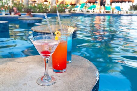 Tropical drinks at swimming pool on holidaysの写真素材