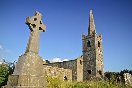 Celtic cross at Irish stone churchの写真素材