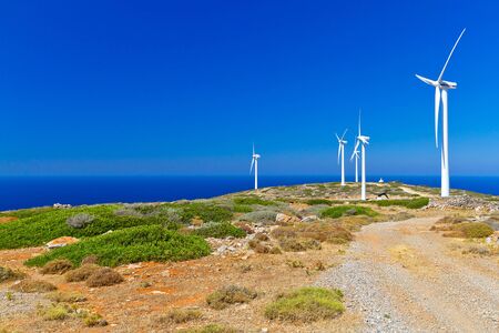 Wind turbines field over blue sky on Crete, Greeceの写真素材