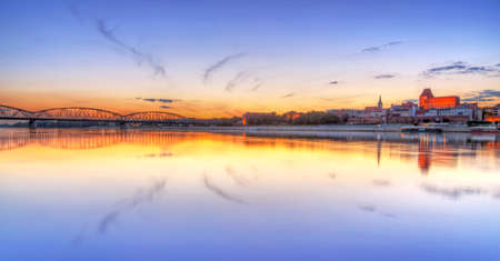 Old town of Torun reflected in Vistula river at sunset, Polandの写真素材