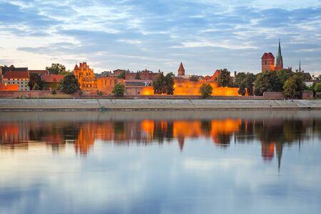 Old town of Torun reflected in Vistula river at sunset, Polandの写真素材