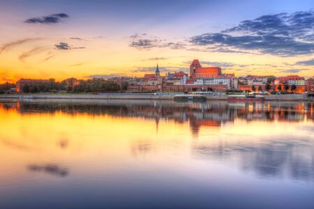 Old town of Torun reflected in Vistula river at sunset, Polandの写真素材