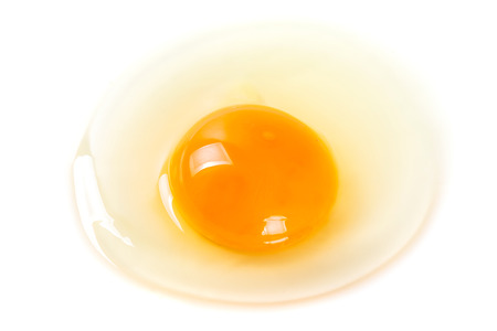 Macro shot of a raw egg on the plate for cookingの写真素材