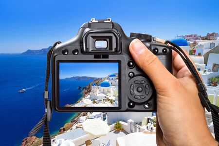 DSLR camera in hand shooting scenery in Santorini, Greeceの写真素材