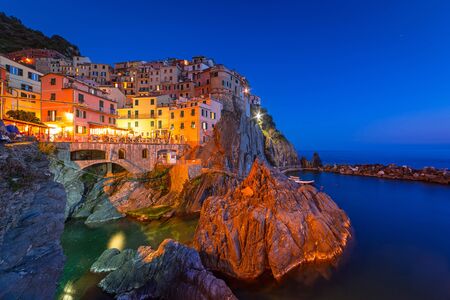 Manarola town on the coast of Ligurian Sea at dusk, Italyの写真素材