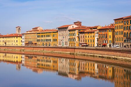 Old town of Pisa with reflection in Arno river, Italyの写真素材