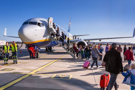 People boarding to Ryanair plane on Lech Walesa Airport in Gdanskのeditorial素材