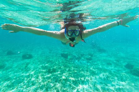 Woman snorkeling in the tropical waterの写真素材