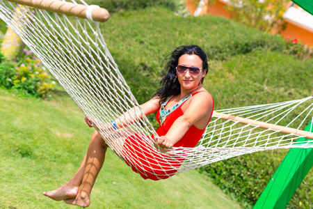 Beautiful woman relaxing on the hammockの写真素材