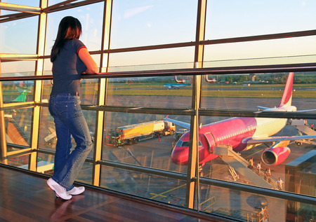 Woman waiting for plane in the airportの写真素材