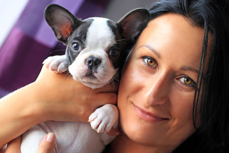 Beautiful woman with french bulldog puppyの写真素材