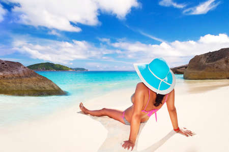 Woman in hat relaxing on the beachの写真素材
