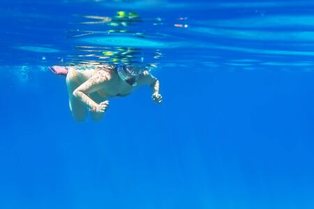 Woman snorkeling in the tropical waterの写真素材