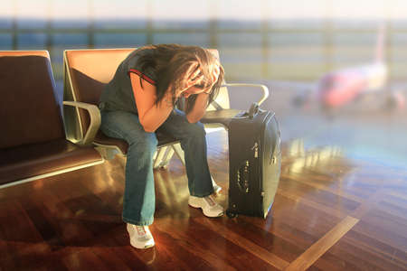 Depressed woman awaiting for delayed planeの写真素材