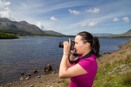 Woman photographer in Connemara mountain terrainsの写真素材