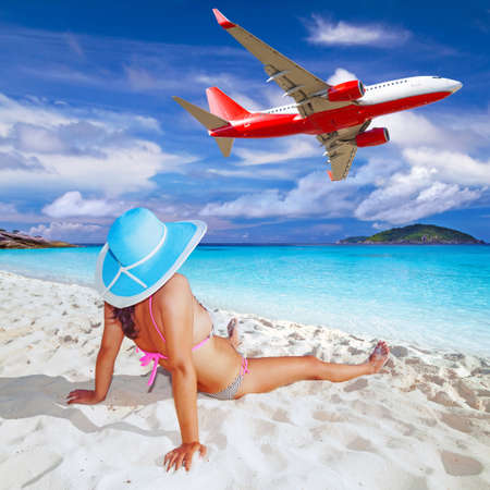 Woman in hat relaxing on the beachの写真素材
