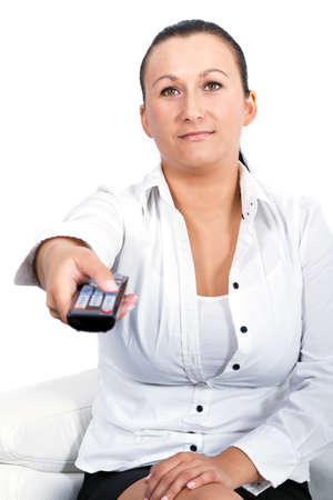 Woman holding the tv remote controlの写真素材