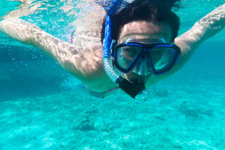 Woman snorkeling in the tropical waterの写真素材