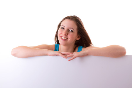 Beautiful brunette holding an empty white boardの写真素材
