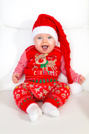 Baby girl posing in santa costume for Christmasの写真素材