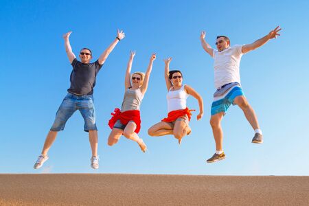 Group of friends jumping in the airの写真素材