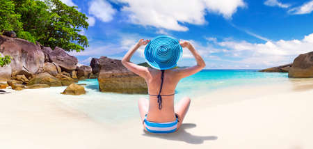 Woman enjoying the sun by the seashoreの写真素材