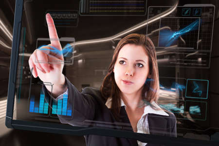 Beautiful woman with interface in futuristic interiorの写真素材