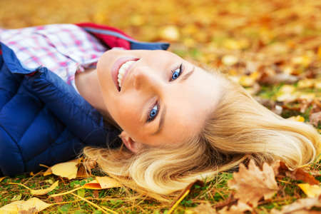 Young beautiful woman at a park in autumnの写真素材