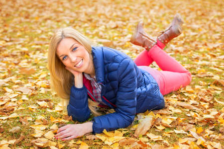 Young beautiful woman at a park in autumnの写真素材