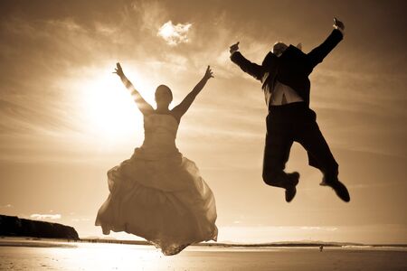 Married couple jumping in the airの写真素材