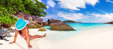 Woman in hat relaxing on the beachの写真素材
