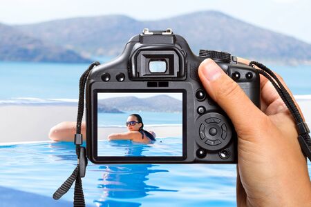 Vacation at swimming pool in Greece with the cameraの写真素材
