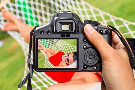 Relaxing vacation on the hammock with the cameraの写真素材