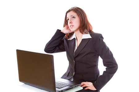 Stressful businesswoman working on laptopの写真素材