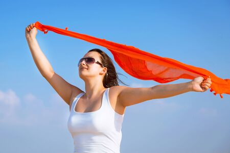 Beautiful woman with scarf in the desertの写真素材