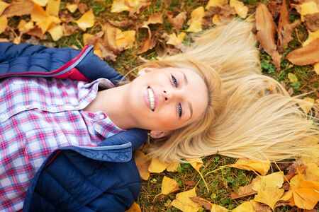 Young beautiful woman at a park in autumnの写真素材