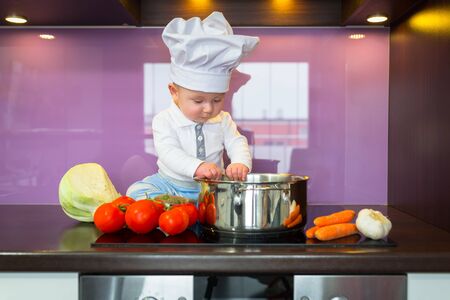 Little chef cooking in the kitchenの写真素材