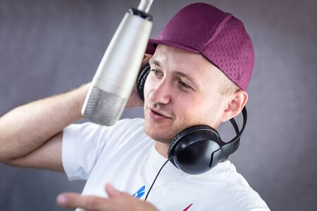Man holding a headphone up his earの写真素材