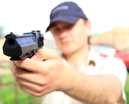 Man holding a gunの写真素材