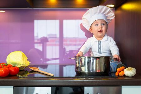 Little chef cooking in the kitchenの写真素材