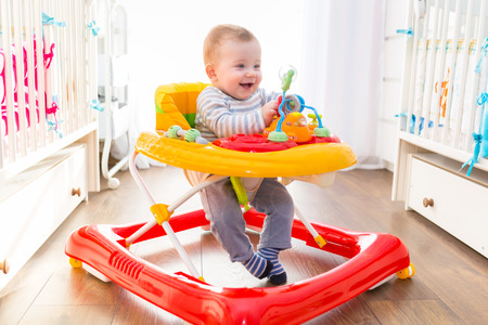 First steps of the boy in a baby walkerの写真素材
