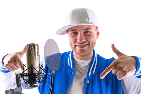 Young man with microphone over white backgroundの写真素材