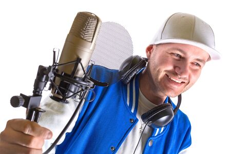 Young man with microphone and headphones over whiteの写真素材